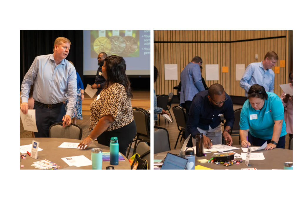 Two groups of people collaborate at tables in a conference or workshop setting with papers and supplies.